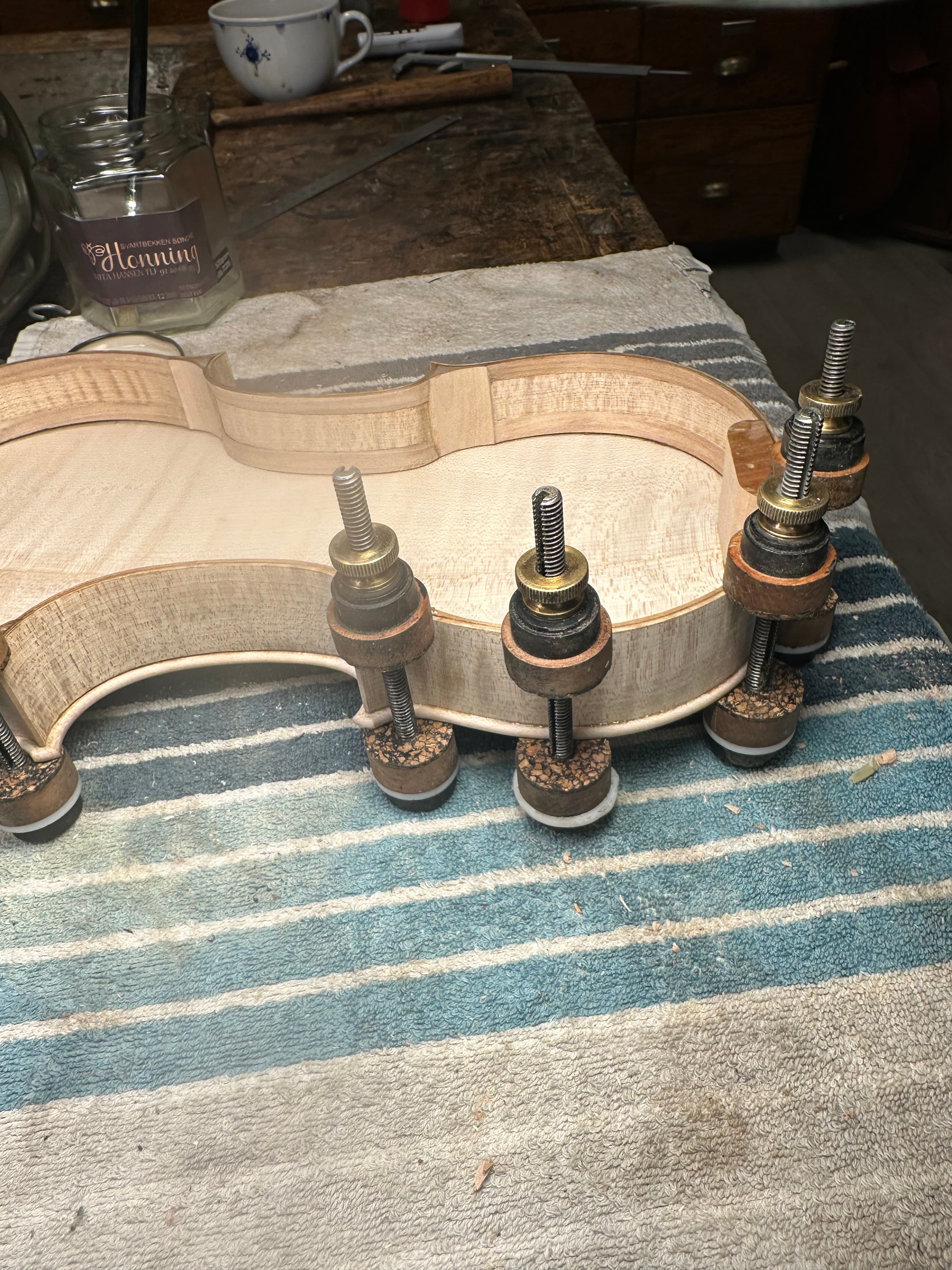 Bending the ribs over a heated iron